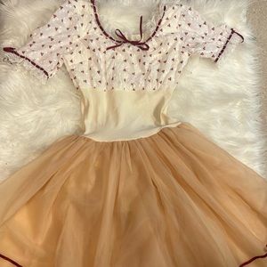 Tan skirt with ribbon on the bottom going around